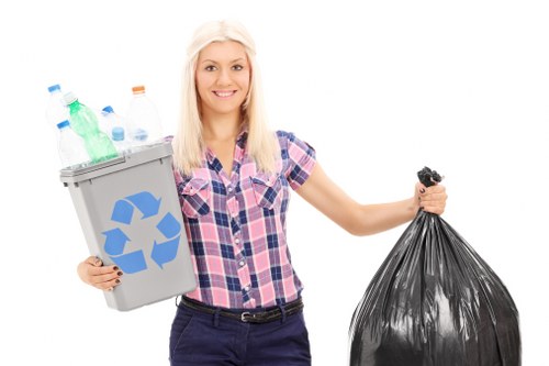Operatives loading a van with cleared household items wearing high-visibility clothing